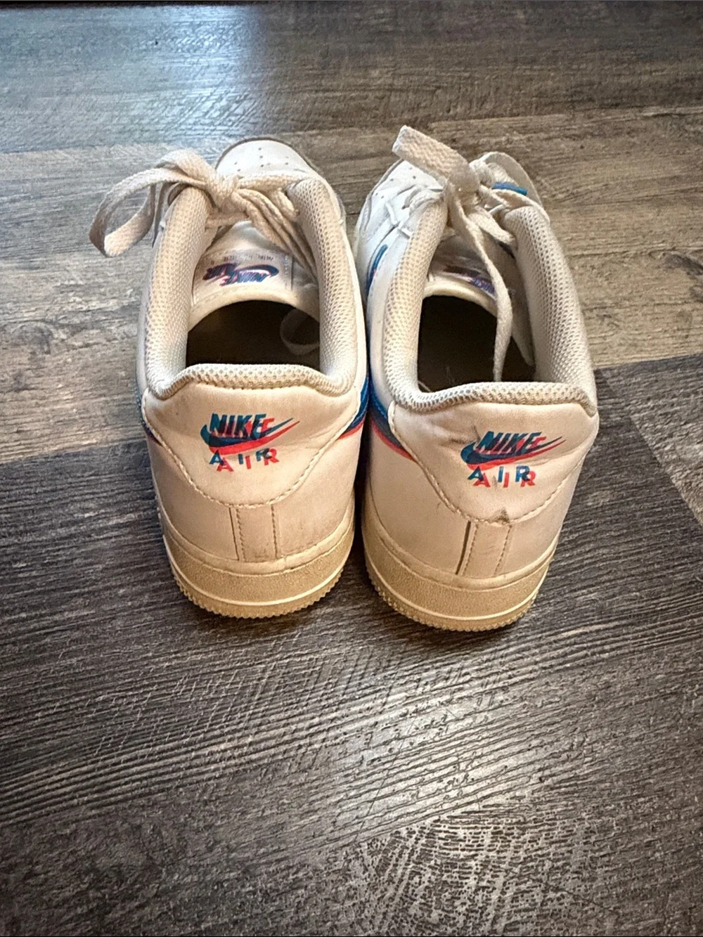 Nike White Low-Top Sneakers with Blue and Red Swoosh